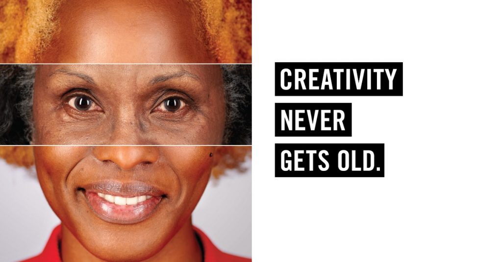 A woman's face with with the words, "Creativity Never Gets Old" written to the left. Her face has a transparent rectangle that goes from the bridge of her nose to above her eyebrows. She appears older and grayer in this section of the picture, but her forehead and hair above the rectangle and below it featuring the tip of her nose, smile and neck appear to be younger.